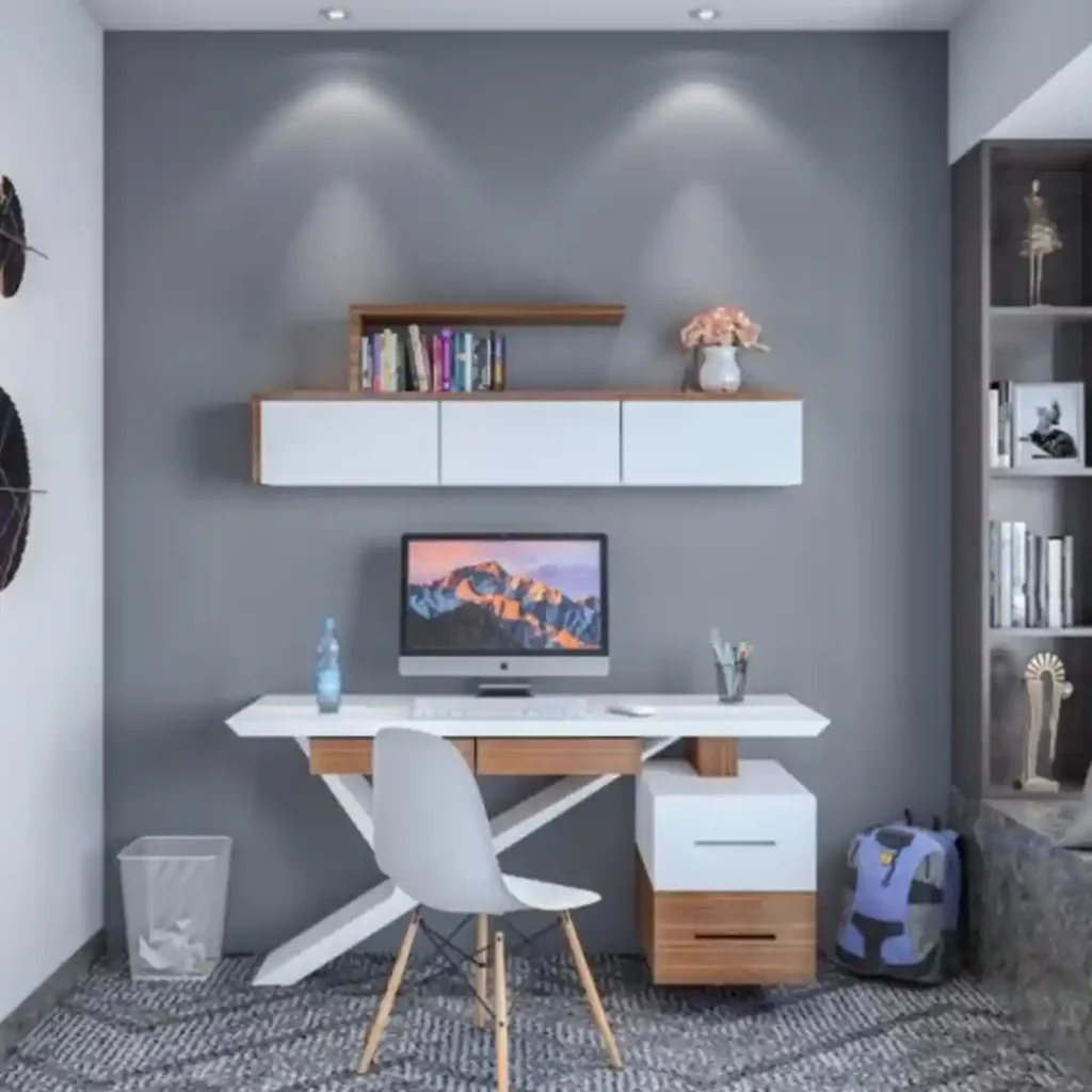 Modern home office with white desk, X-frame legs, floating shelf, gray wall, and ambient lighting — sleek workspace design