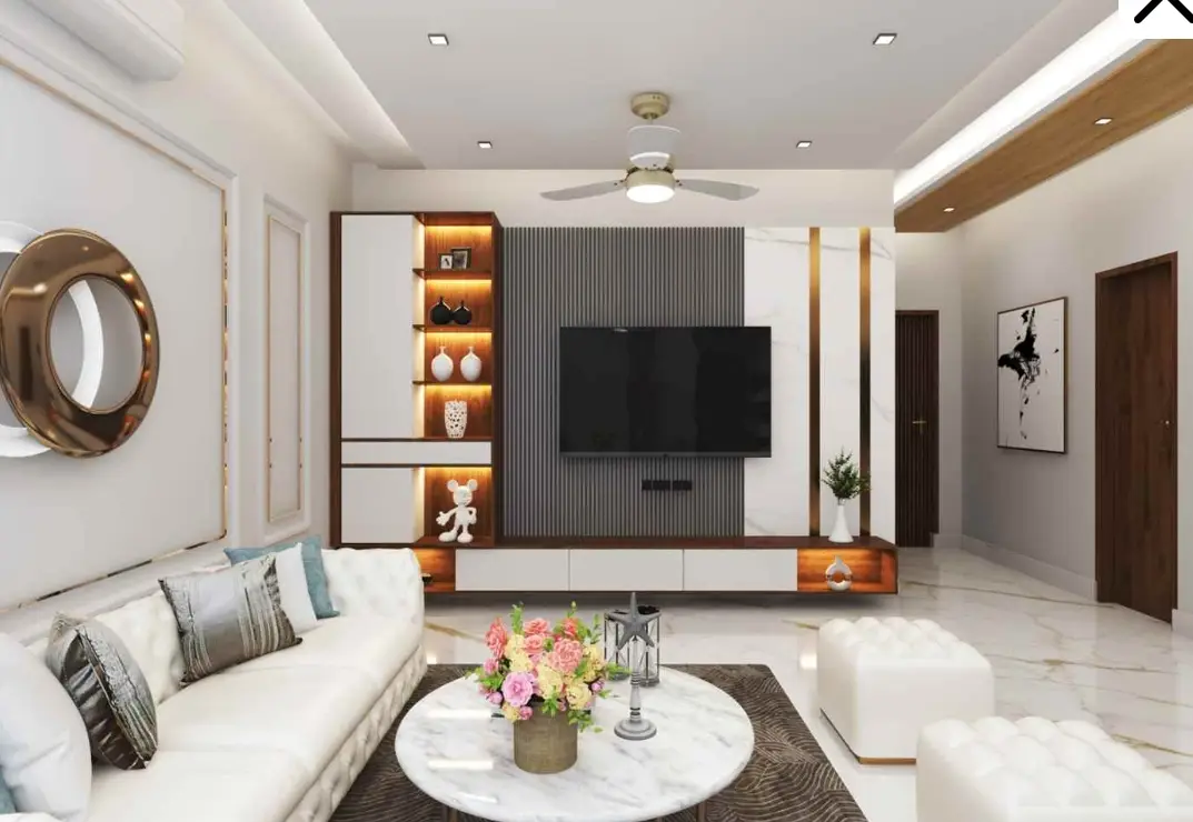 Modern living room with a stylish TV unit, white sofa, marble flooring, and ambient lighting, perfect for homes in Delhi NCR.
