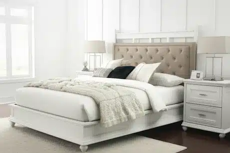 Elegant white bedroom set with a tufted beige headboard, matching nightstands, and soft bedding, ideal for modern homes in Delhi NCR
